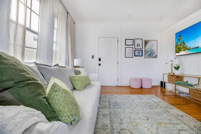 a living room with furniture and a rug