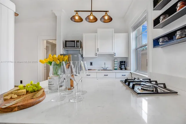 a kitchen with stainless steel appliances granite countertop a sink and cabinets