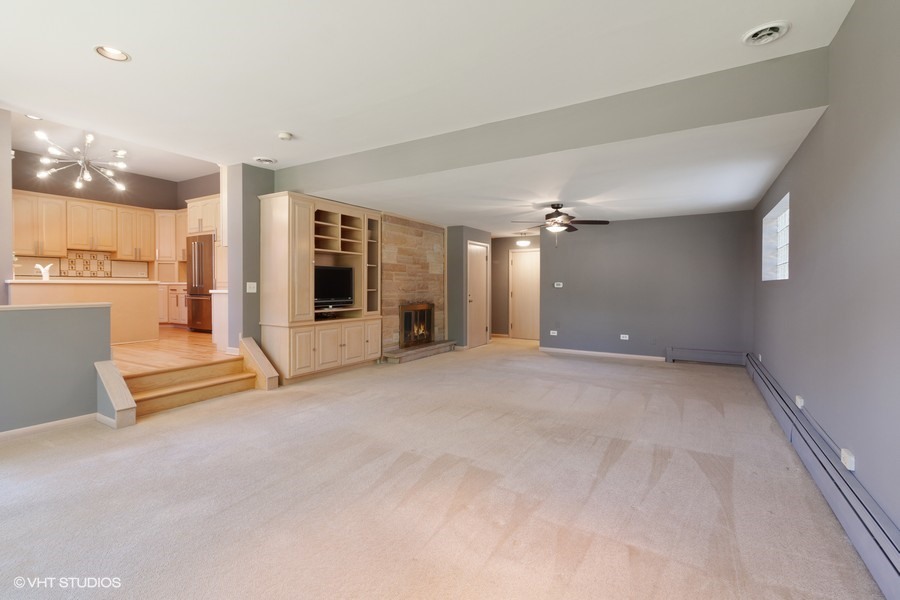 399 Audubon Road Riverside, IL 60546 - Photo 11 of 31 an empty room with chandelier fan and windows