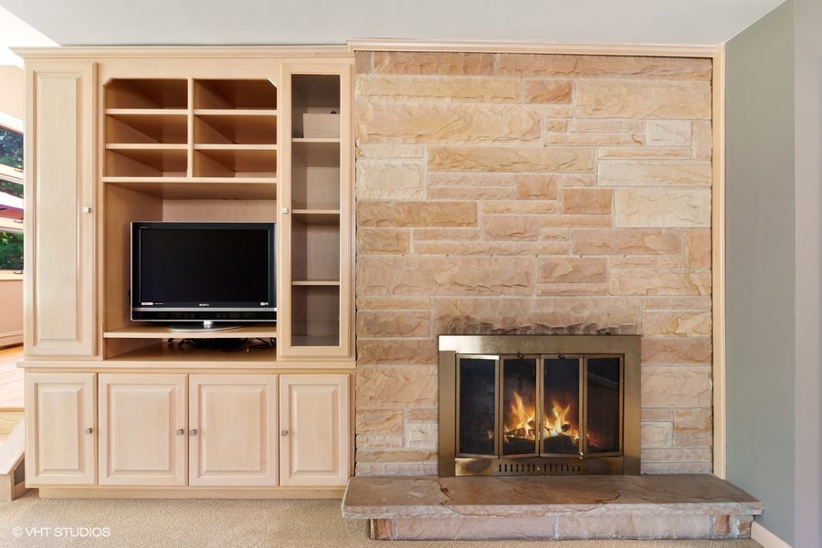 399 Audubon Road Riverside, IL 60546 - Photo 12 of 31 a living room with a flat screen tv and a fireplace