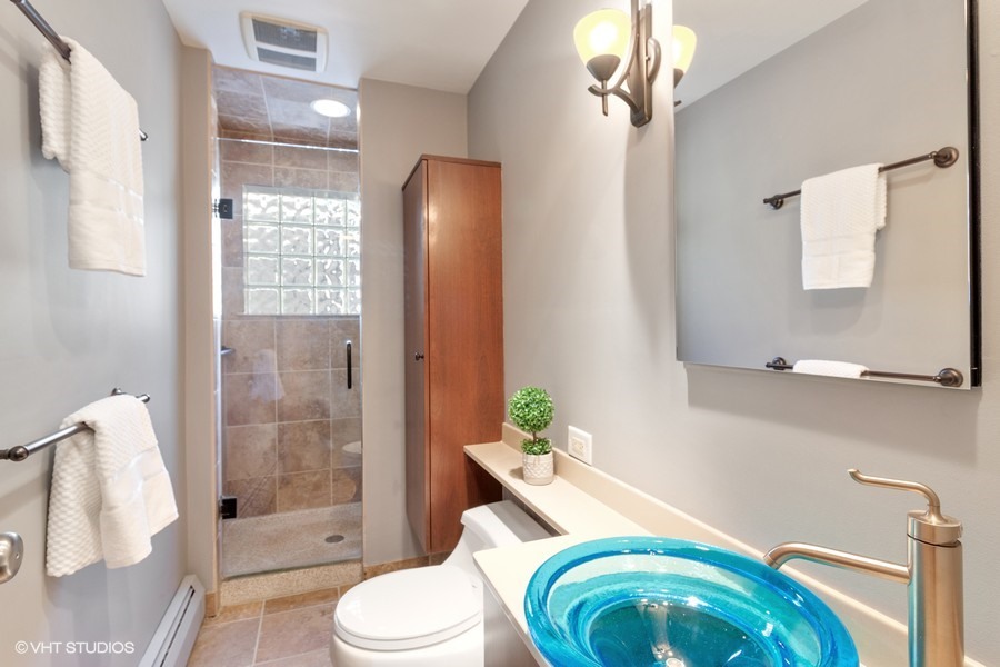 399 Audubon Road Riverside, IL 60546 - Photo 14 of 31 a bathroom with a sink toilet and shower