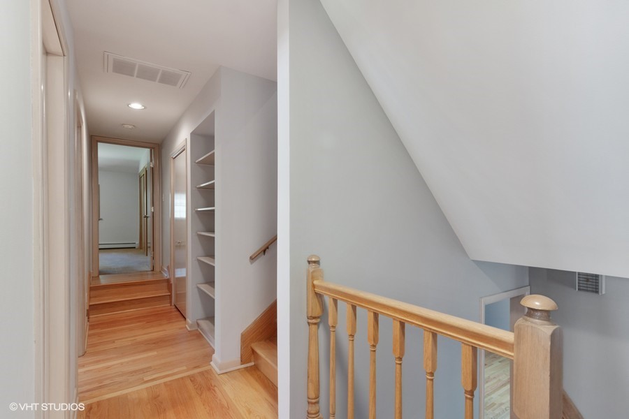 399 Audubon Road Riverside, IL 60546 - Photo 16 of 31 a view of a hallway with wooden floor and staircase