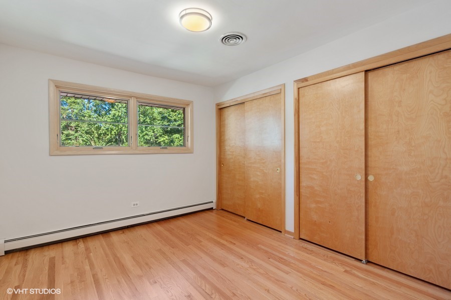 399 Audubon Road Riverside, IL 60546 - Photo 23 of 31 an empty room with wooden floor and windows