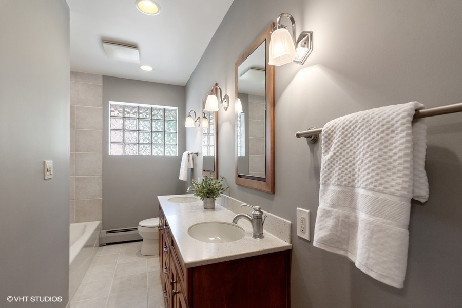 399 Audubon Road Riverside, IL 60546 - Photo 24 of 31 a bathroom with a sink vanity granite and a mirror