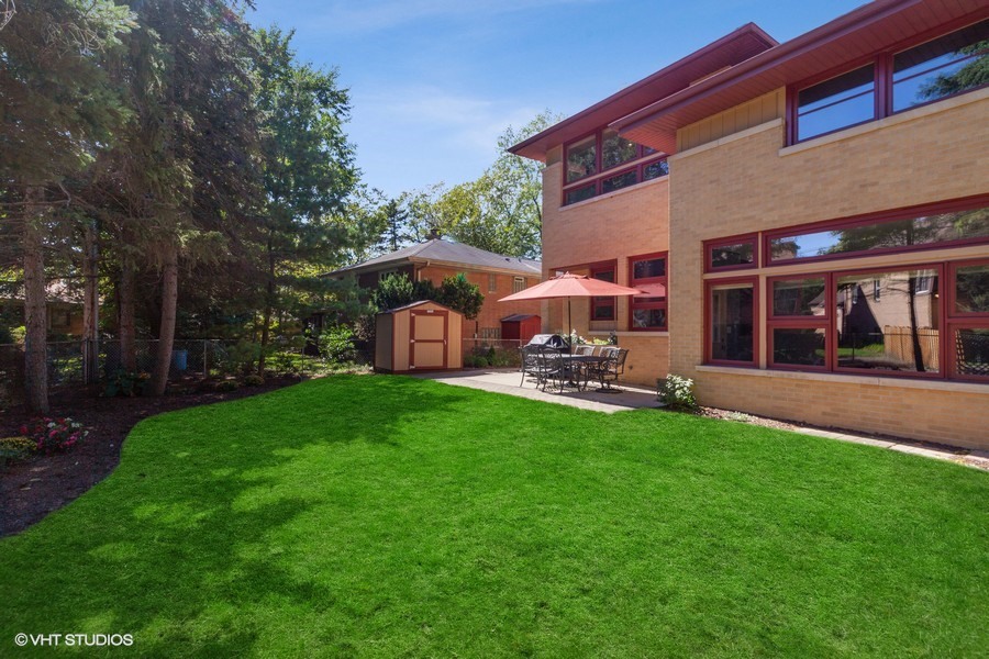 399 Audubon Road Riverside, IL 60546 - Photo 29 of 31 a view of a patio with table and chairs under an umbrella