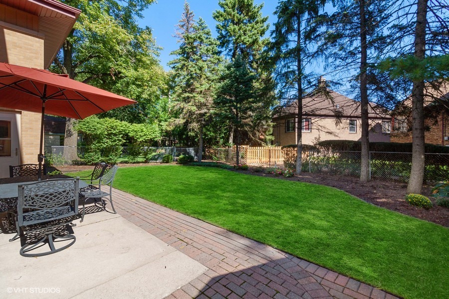 399 Audubon Road Riverside, IL 60546 - Photo 30 of 31 a view of a backyard with couches plants and large trees