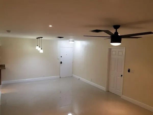 a view of a livingroom with a ceiling fan and window