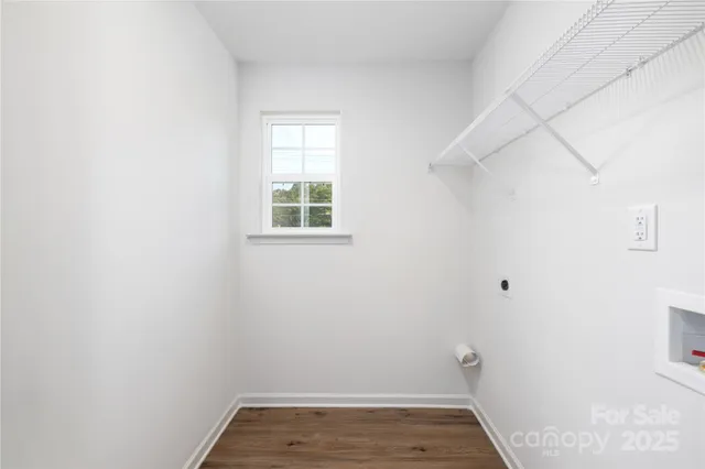 a view of small space with wooden floor and a window