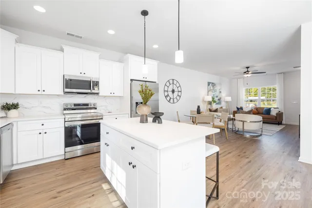 a kitchen with a stove cabinets and wooden floor