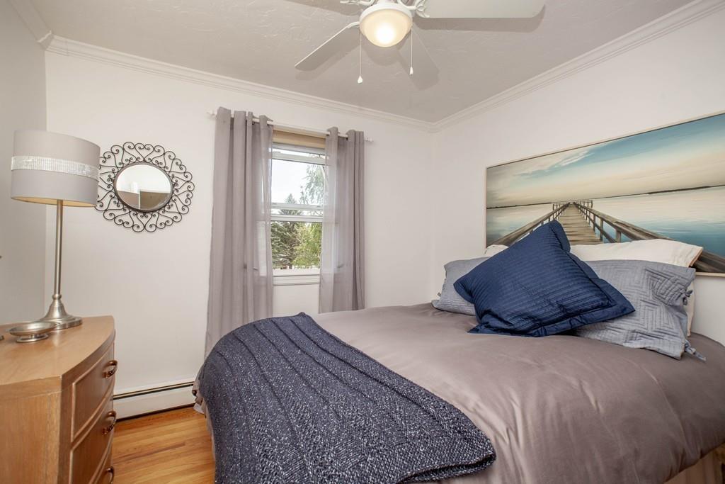 44 Dolan Road Millbury, MA 01527 - Photo 23 of 40 a bedroom with a large bed and a chandelier