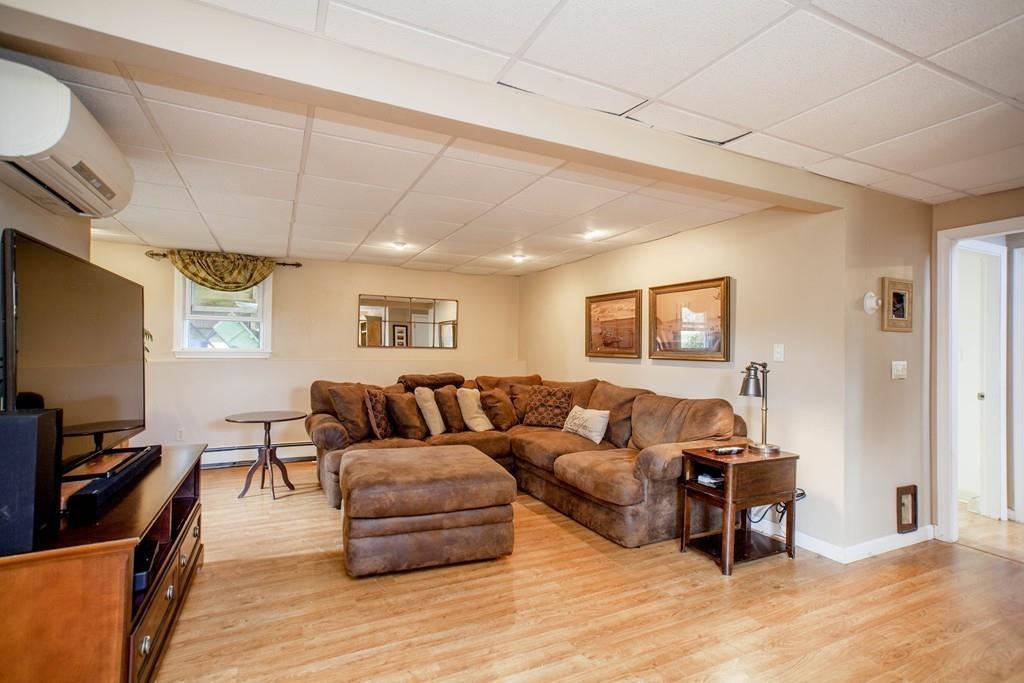 44 Dolan Road Millbury, MA 01527 - Photo 27 of 40 a living room with furniture and a flat screen tv