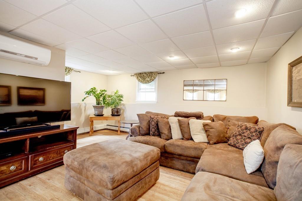 44 Dolan Road Millbury, MA 01527 - Photo 28 of 40 a living room with furniture and a flat screen tv