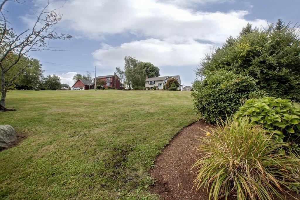 44 Dolan Road Millbury, MA 01527 - Photo 37 of 40 a view of a big yard with plants and a large tree