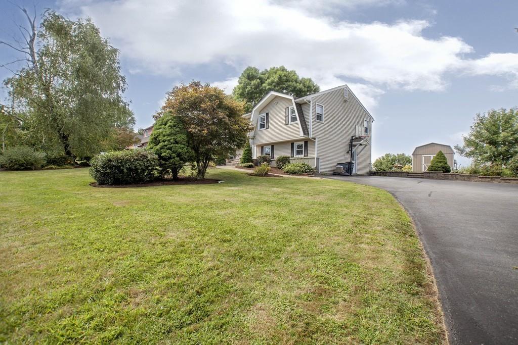 44 Dolan Road Millbury, MA 01527 - Photo 39 of 40 a front view of a house with a garden and trees