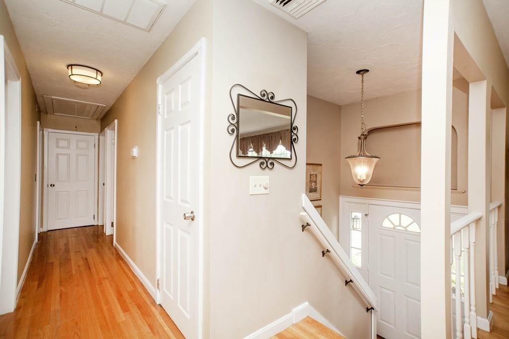 44 Dolan Road Millbury, MA 01527 - Photo 5 of 40 a view of a hallway with wooden floor and staircase