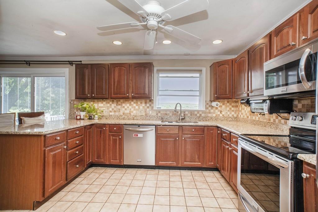 44 Dolan Road Millbury, MA 01527 - Photo 7 of 40 a kitchen with stainless steel appliances granite countertop a stove sink and cabinets