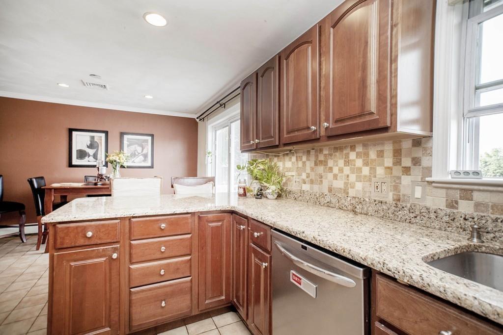 44 Dolan Road Millbury, MA 01527 - Photo 10 of 40 a kitchen with granite countertop a sink a stove cabinets and wooden floor