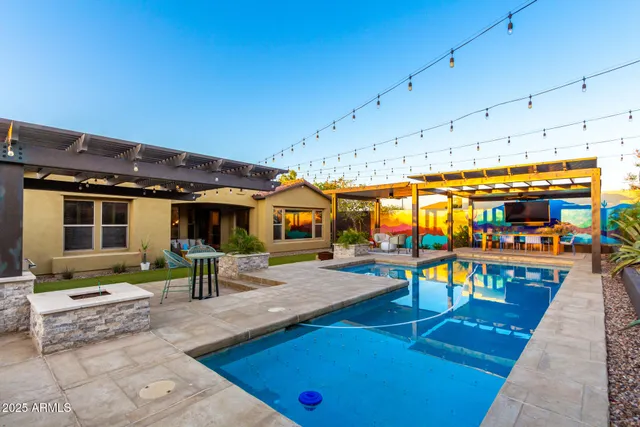a view of a swimming pool with chairs in the patio