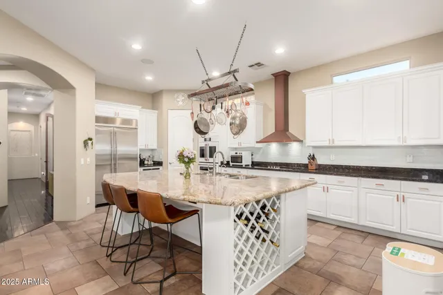 a bedroom with a bed couch and a flat tv screen