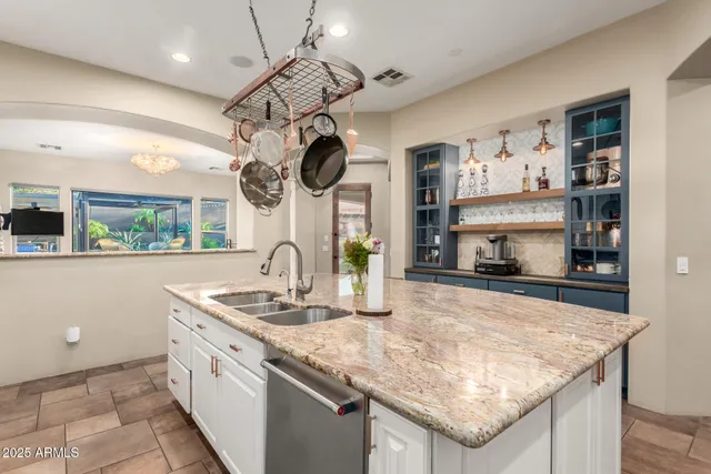 a bathroom with double vanity sinks and a mirror