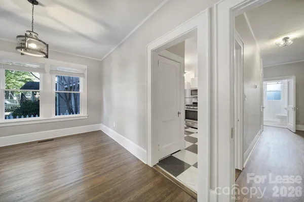 a view of a hallway with wooden floor and staircase