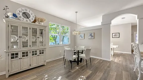 a view of a dining room with furniture and wooden floor