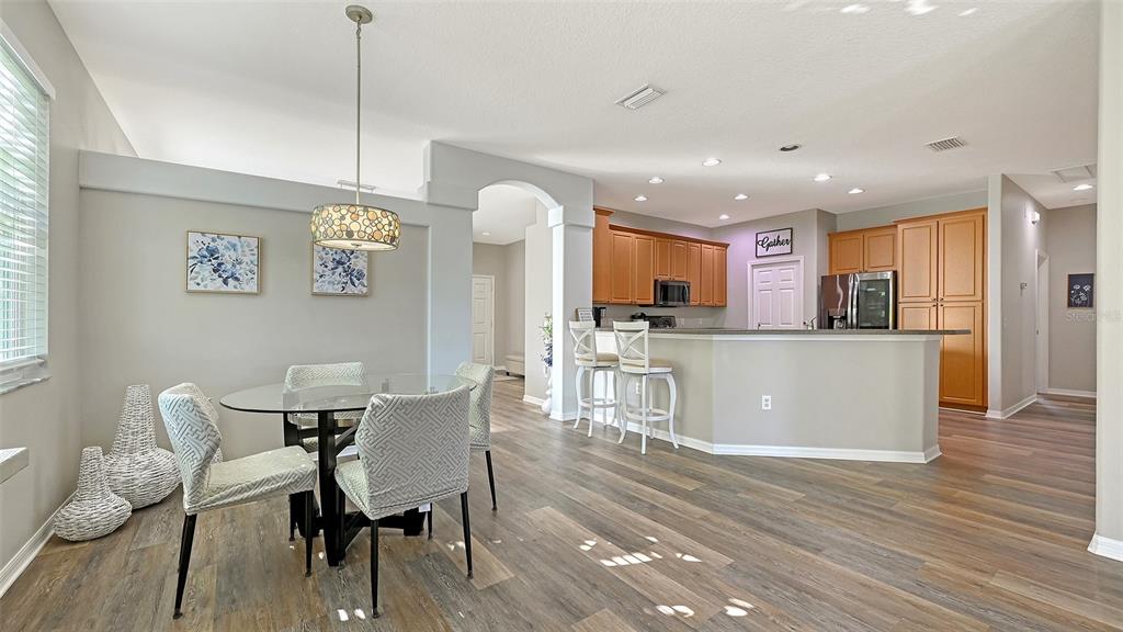 12274 23rd Street East Parrish, FL 34219 - Photo 13 of 64 a view of a dining room with furniture and wooden floor