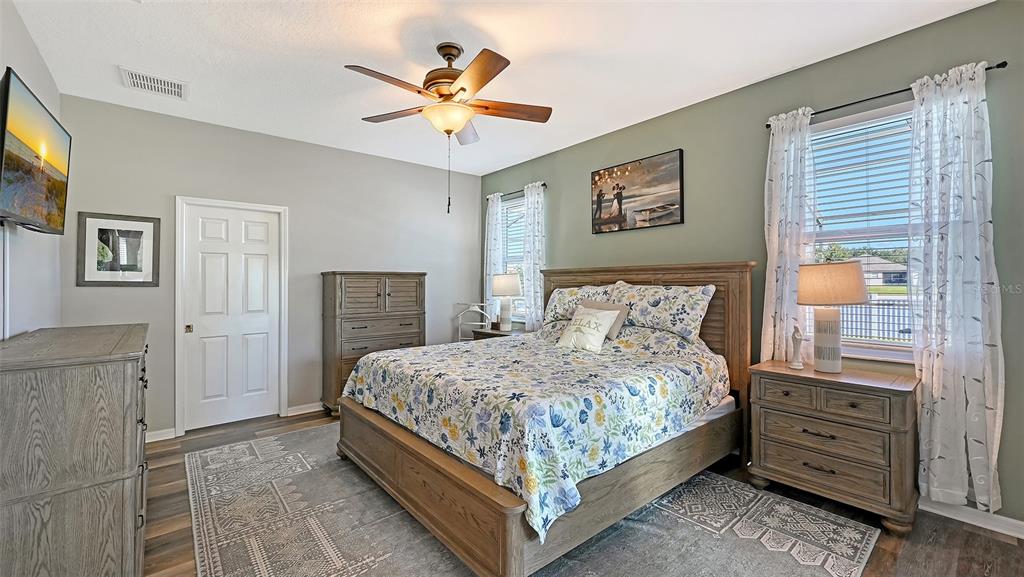 12274 23rd Street East Parrish, FL 34219 - Photo 17 of 64 a bedroom with a bed and a chandelier