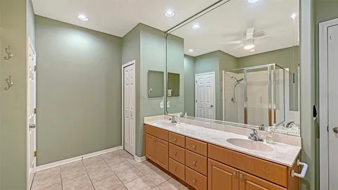 a bathroom with a tub a sink and a mirror