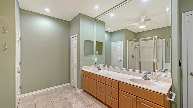 a bathroom with a tub a sink and a mirror