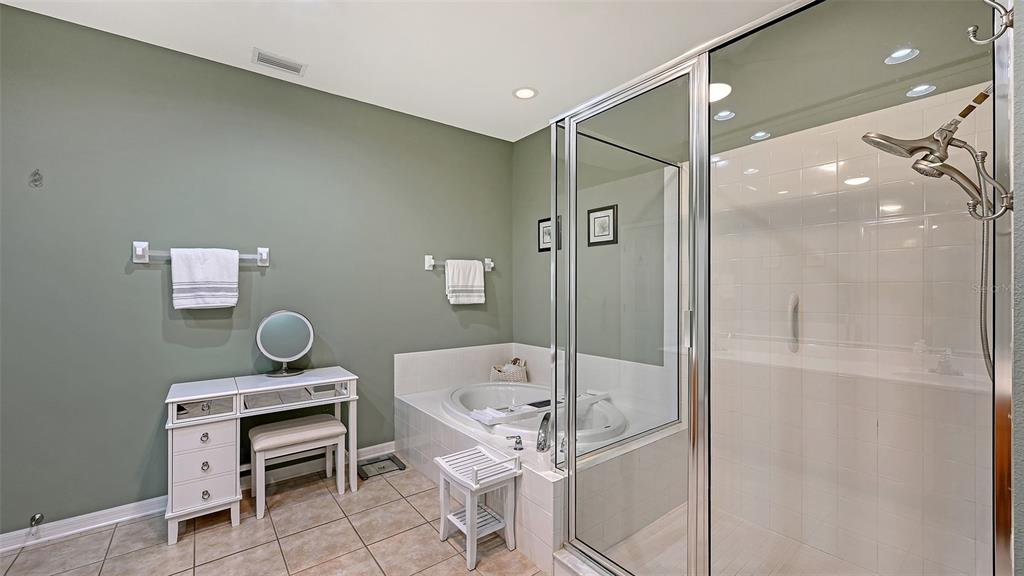 12274 23rd Street East Parrish, FL 34219 - Photo 21 of 64 a bathroom with a bathtub a sink and a shower