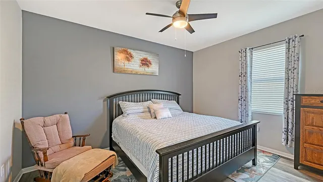 a bedroom with a bed and painting on the wall