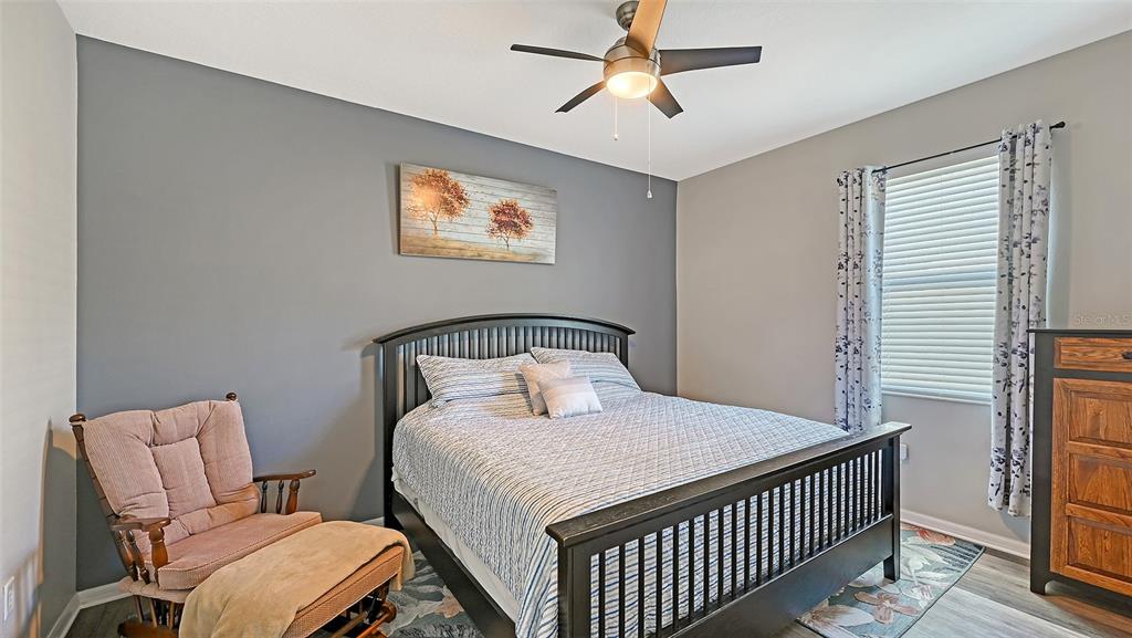 12274 23rd Street East Parrish, FL 34219 - Photo 22 of 64 a bedroom with a bed and a chandelier