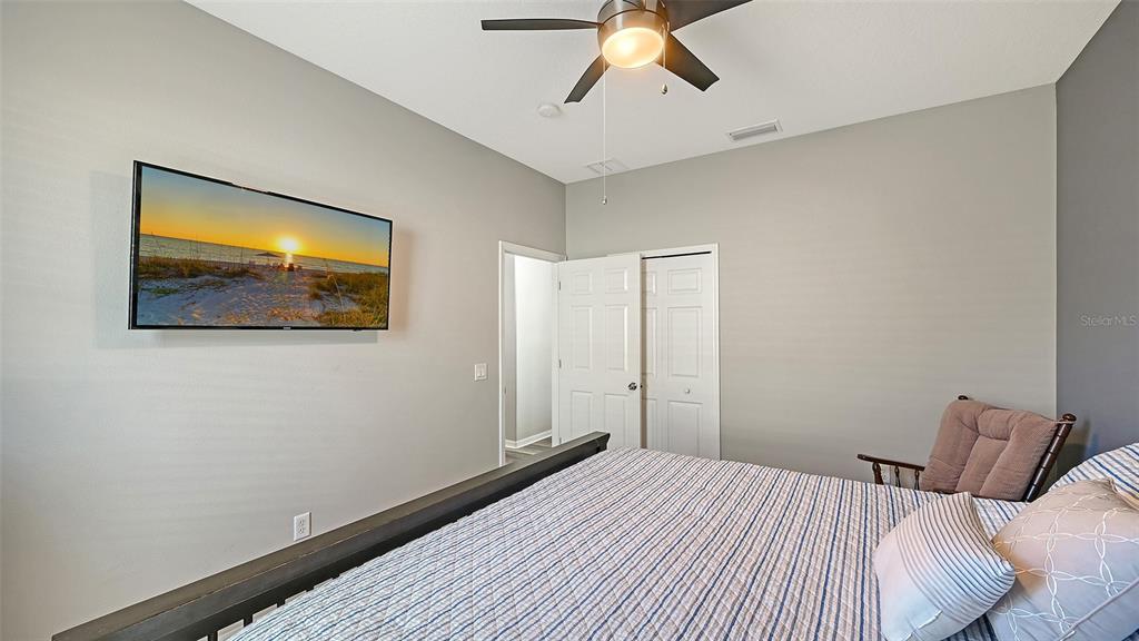 12274 23rd Street East Parrish, FL 34219 - Photo 23 of 64 a bedroom with a bed and painting on the wall
