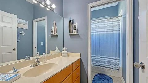 a living room with furniture and a ceiling fan