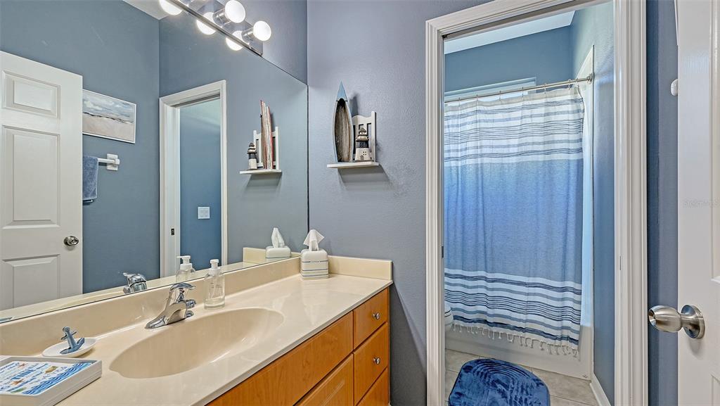 12274 23rd Street East Parrish, FL 34219 - Photo 24 of 64 a bathroom with a sink a vanity and a mirror