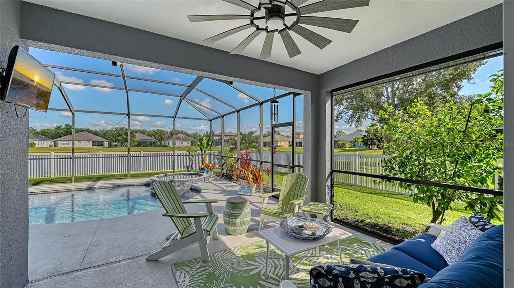 12274 23rd Street East Parrish, FL 34219 - Photo 30 of 64 a view of a patio with table and chairs potted plants with wooden floor