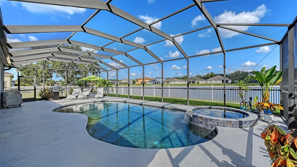 12274 23rd Street East Parrish, FL 34219 - Photo 32 of 64 a view of a swimming pool with a patio
