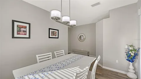 a view of a dining room with furniture wooden floor and chandelier