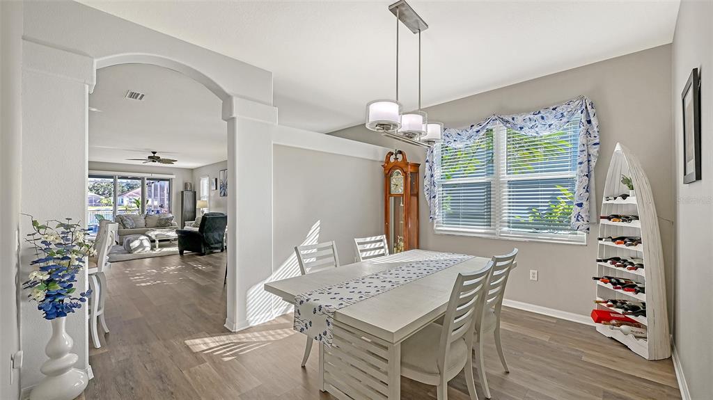12274 23rd Street East Parrish, FL 34219 - Photo 6 of 64 a view of a dining room with furniture wooden floor and chandelier