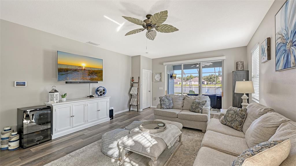 12274 23rd Street East Parrish, FL 34219 - Photo 9 of 64 a living room with furniture ceiling fan and a rug