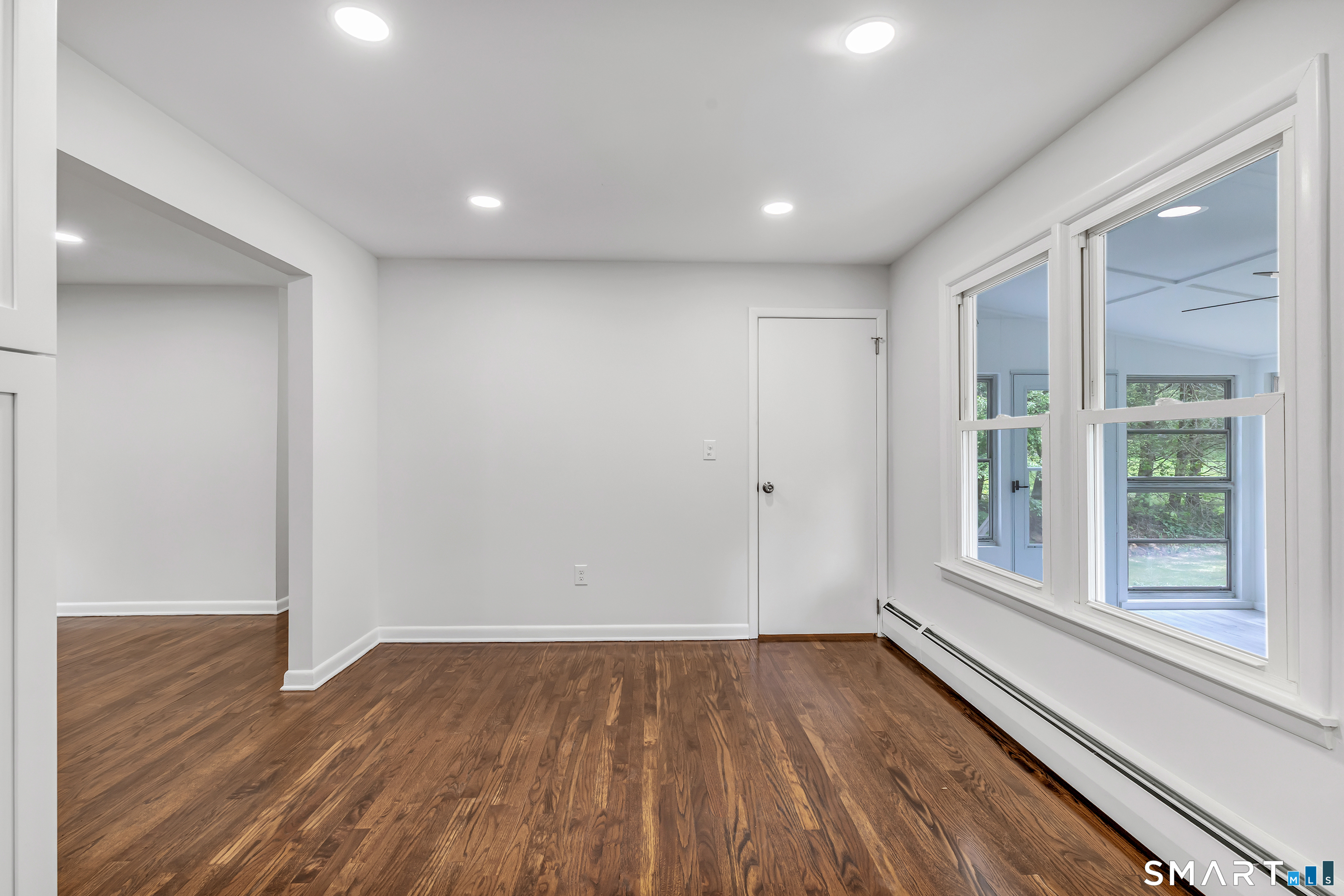 7 Longview Road Newtown, CT 06482 - Photo 8 of 40 a view of an empty room with wooden floor and a window