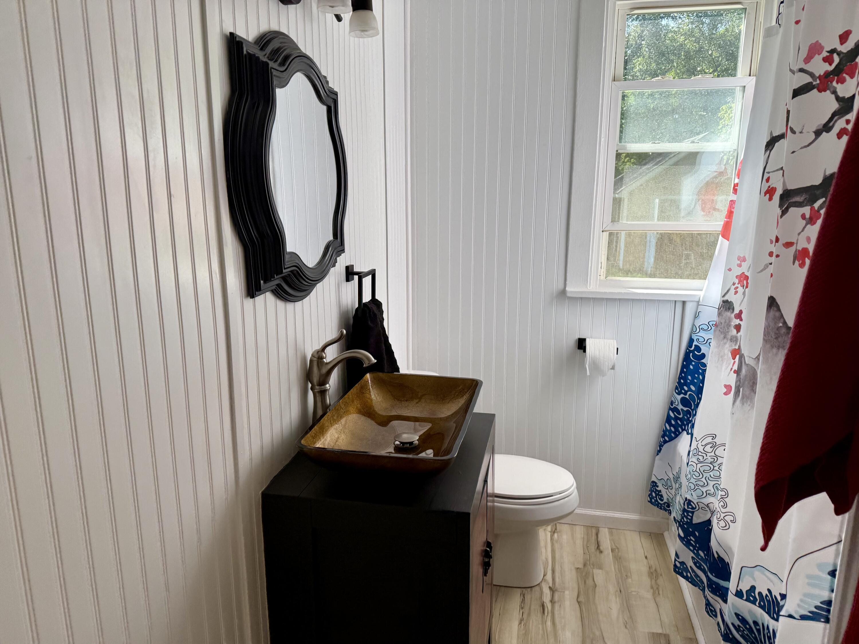 1038 Ridge Street Hammond, IN 46324 - Photo 14 of 31 a bathroom with a toilet sink vanity and mirror