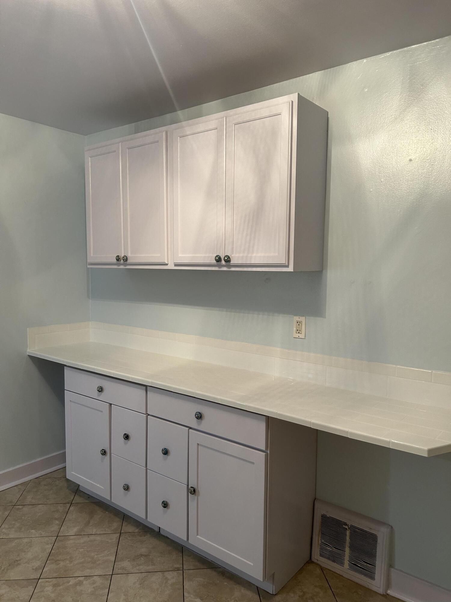 1038 Ridge Street Hammond, IN 46324 - Photo 20 of 31 a kitchen with white cabinets