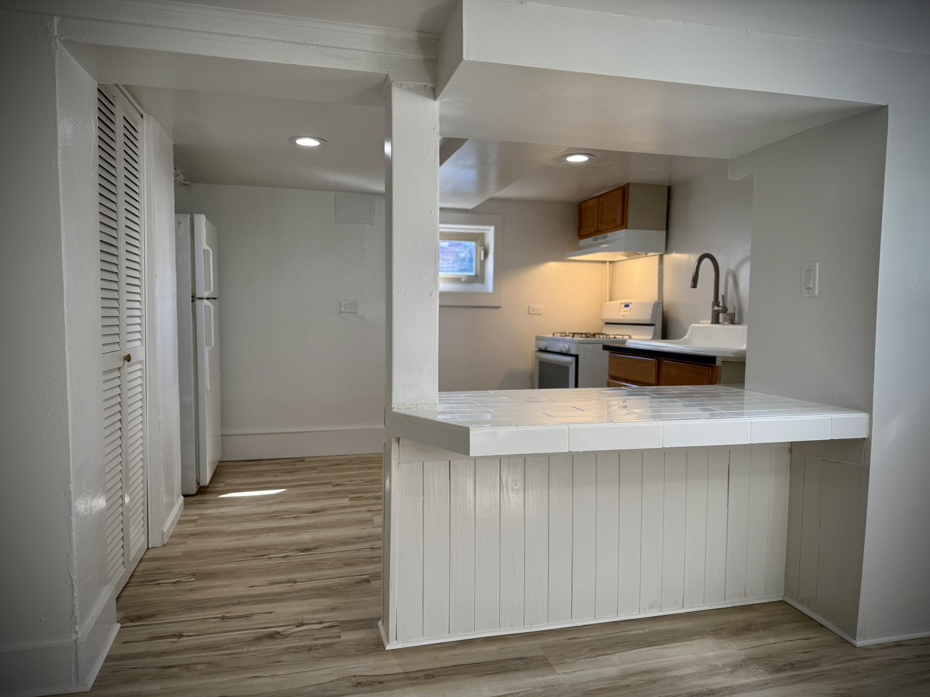 1038 Ridge Street Hammond, IN 46324 - Photo 26 of 31 a open kitchen with white cabinets and a sink
