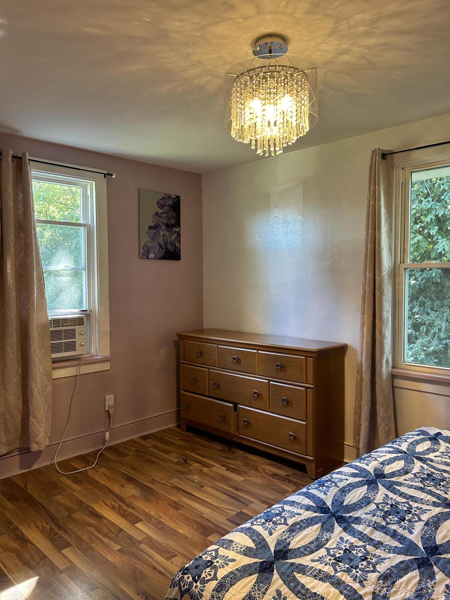 1038 Ridge Street Hammond, IN 46324 - Photo 8 of 31 a bedroom with a bed and a chandelier