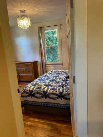 a bedroom with a bed and a mirror