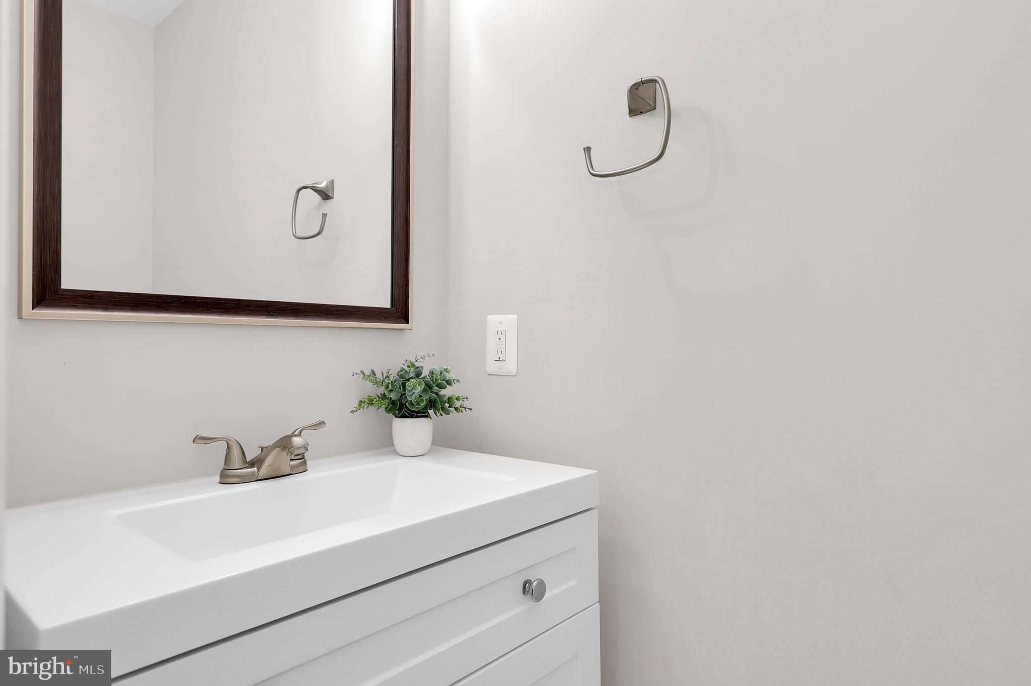 14901 Running Ridge Lane Silver Spring, MD 20906 - Photo 11 of 49 a bathroom with a sink and mirror