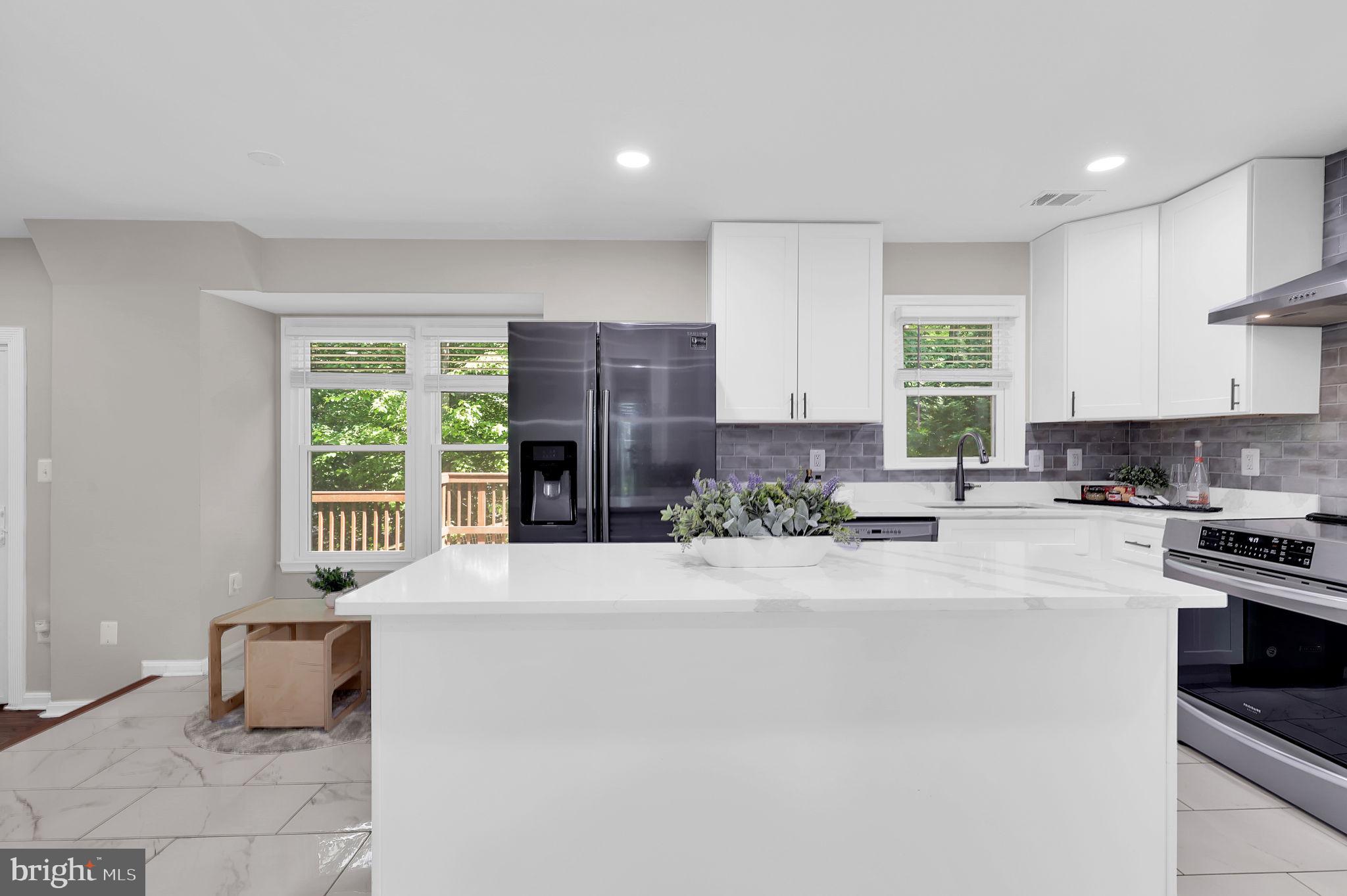 14901 Running Ridge Lane Silver Spring, MD 20906 - Photo 13 of 49 a large white kitchen with a window and refrigerator