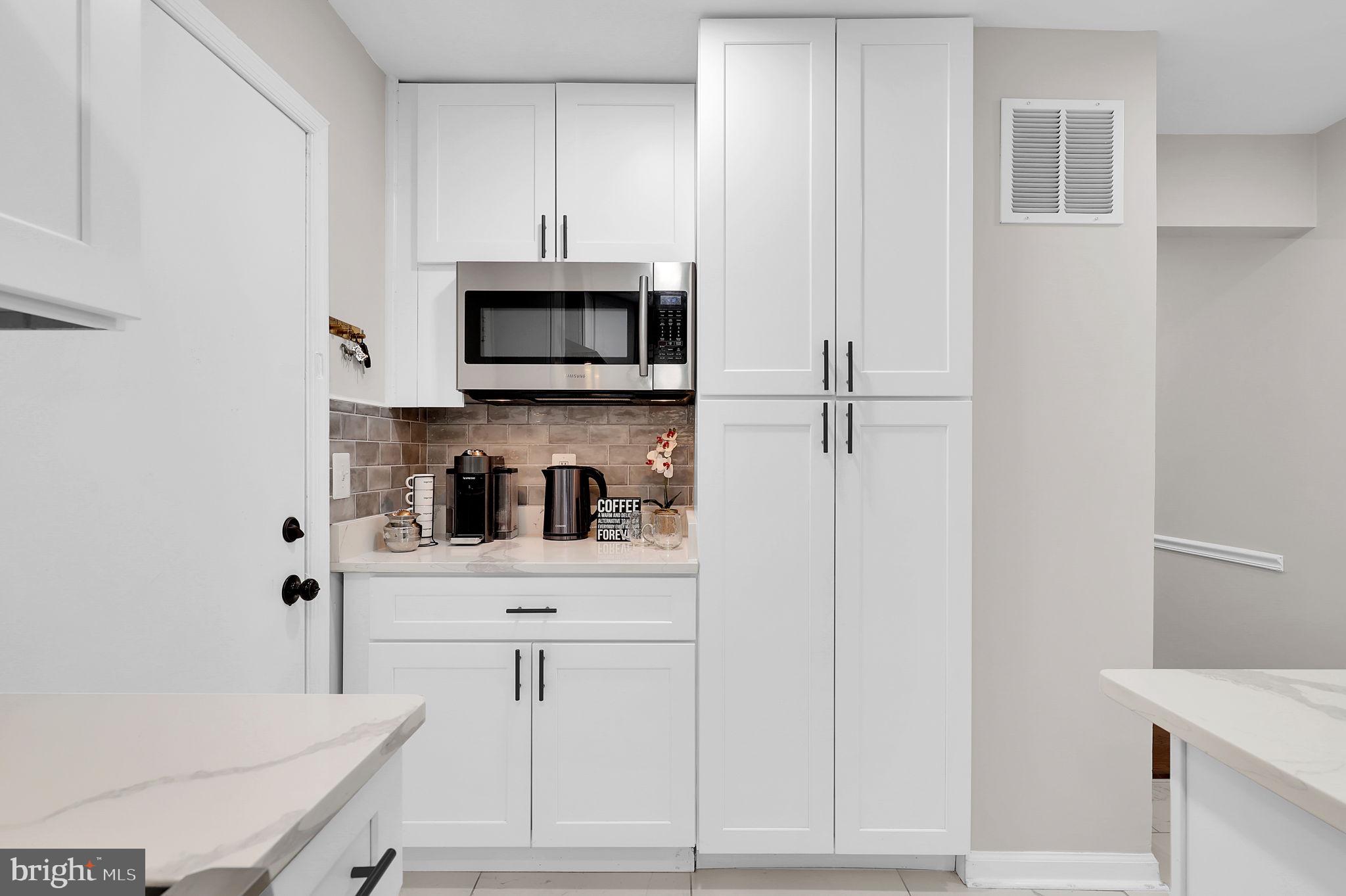 14901 Running Ridge Lane Silver Spring, MD 20906 - Photo 15 of 49 a kitchen with stainless steel appliances a cabinets and a refrigerator